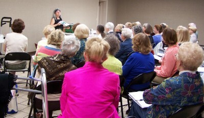 An attentive audience listens to Merle  Rosen's acrylic presentation.